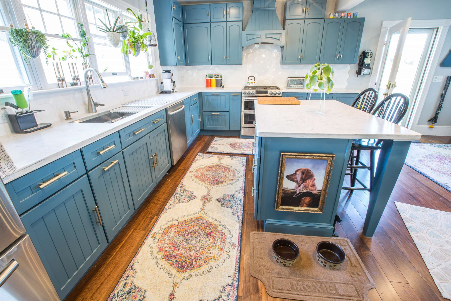 Warm blue refinished kitchen cabinets with white countertops