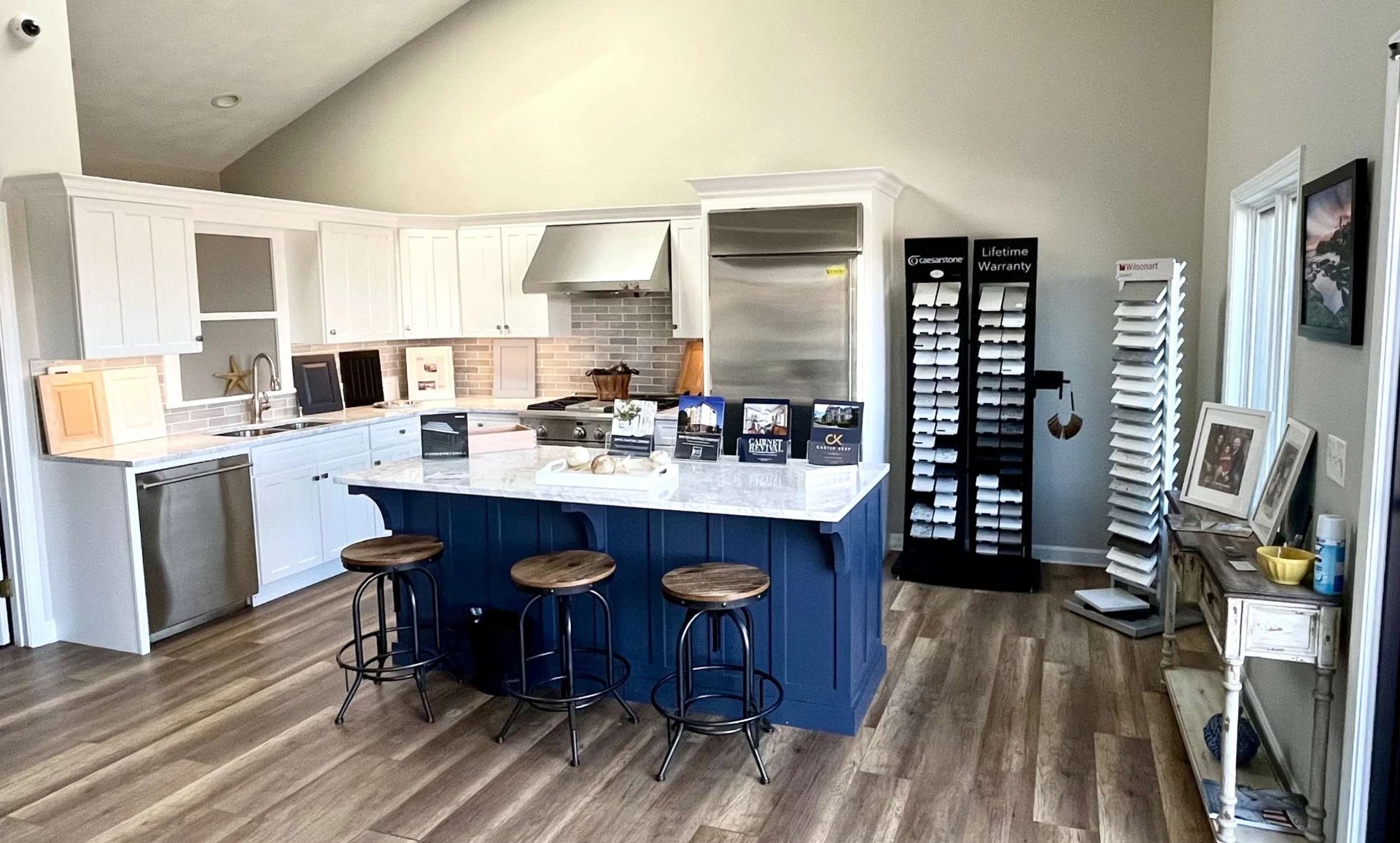 Cabinet Revival showroom with sample doors, countertops and a navy island